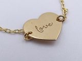 gold plated heart necklace with love written on it