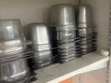many pots and pans on the shelves in the kitchen