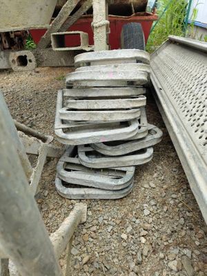 a pile of old metal items on the ground next to a truck