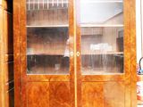 a large wooden cabinet with glass doors in a room