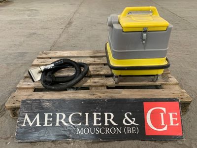 a yellow and gray cooler sitting on a pallet next to a sign that says mercierr and c e