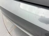 a close up of a car ' s front bumper with scratches on it