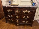 a marble top chest of drawers in a room