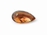 a close up of a faceted brown diamond on a white background