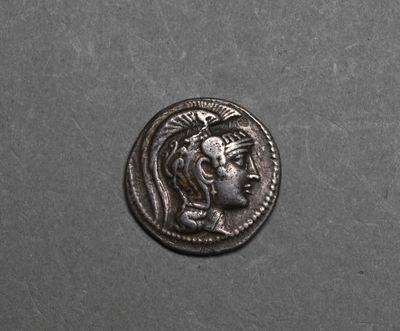 a silver coin with an image of a woman on it