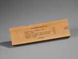 wooden business card holder with business card on it on a gray surface