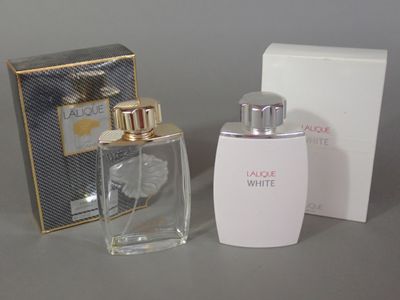 a bottle of perfume next to a box on a table