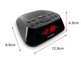 an image of a black alarm clock sitting on top of a white surface