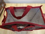 a red bag that is sitting on the floor