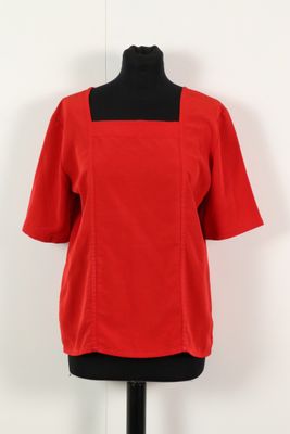 a red top on a mannequin mannequin stand