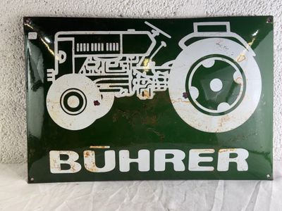 a green sign with a picture of a tractor on it