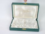 a small green box with a silver ring inside of it