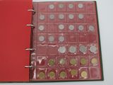 a red binder with a lot of coins on it