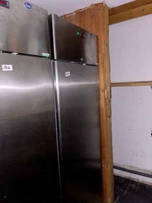 a stainless steel refrigerator in the corner of a room