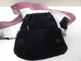 a small black bag with a pink strap on it