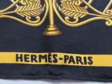 a close up of a black and gold tie with gold trim