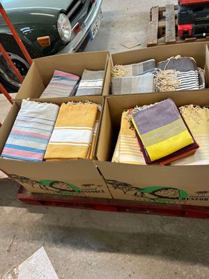 une boîte remplie de serviettes pliées posée sur un carton
