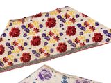 two pieces of cloth with floral designs on them on a white surface
