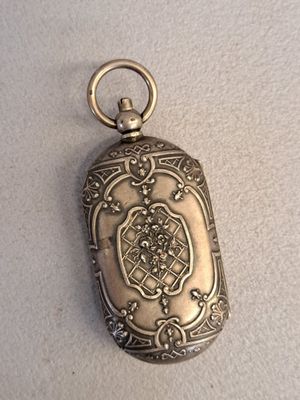 an antique silver locke with a chain hanging from it ' s side