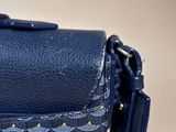 a close up of a blue purse with a yellow and white pattern