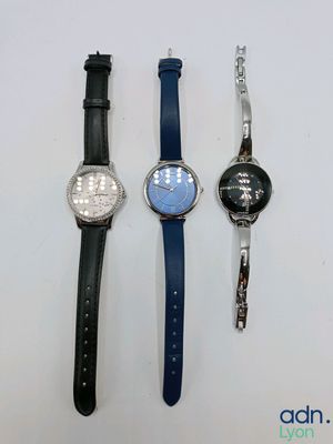 four different watches are lined up on a white surface