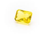 a yellow sapphire stone on a white background