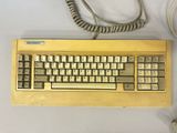 a computer keyboard with a cord attached to it