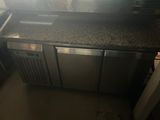 a kitchen with a stove, sink, and refrigerator in it