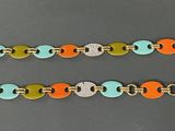 a close up of a colorful bracelet with a metal clasp