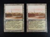 these are two cards with a picture of a city in the background