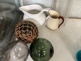 many different colored vases on a shelf next to each other