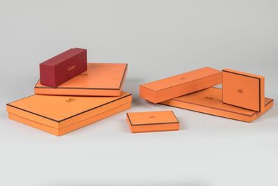 several orange boxes are stacked on top of each other on a white surface