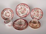 five pieces of china on display on a table