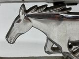 a silver horse that is running on a table