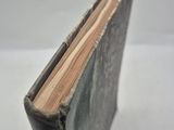 a close up of a book on a table with a white background
