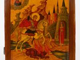 an old wooden box with a painting of a man on a horse in front of a castle