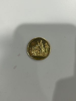 a gold coin with a picture of a man and a woman on it