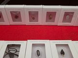 several boxes of earphones are lined up on a red surface