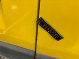 a sticker on the side of a yellow car