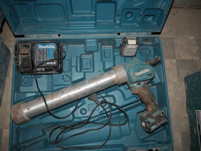 a blue tool in a blue case with a cord