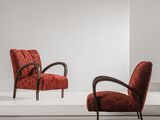 two red chairs in a white room with a white floor