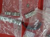 four bags of assorted electronic components on a red surface