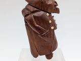 an image of a sculpture of a man in a coat and hat