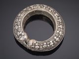 an old silver bracelet with a snake head on top of it
