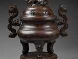 a large bronze incense vessel with lions on top of it