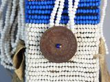 a close up of a cell phone case with beads and a button