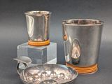 two cups and a bowl sitting on a table