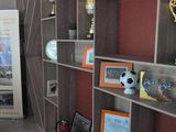 a room with many shelves and pictures on the wall