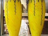 deux vases jaunes exposés dans une vitrine