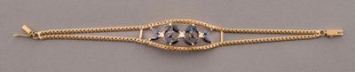 gold - plated bracelet with a faceted blue topaz stone